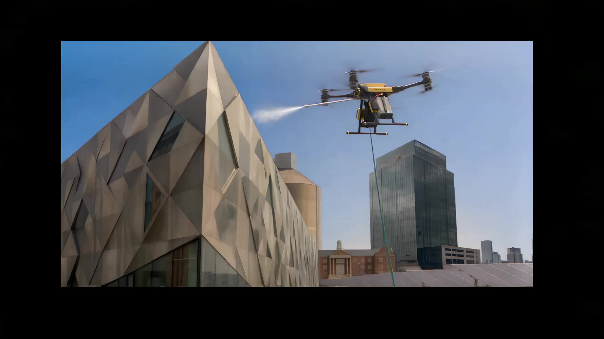 SpiderJet tethered drone spraying a commercial building facade